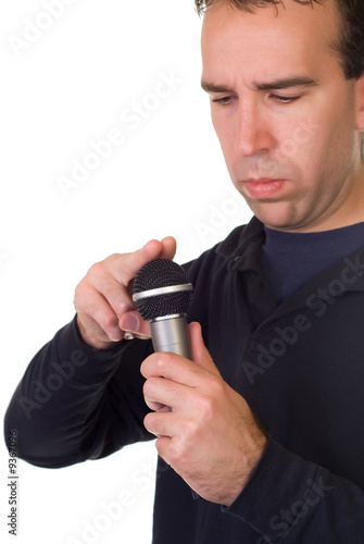 A man tapping the microphone to see if it works