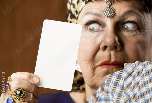 Gypsy fortune teller hiolding a blank tarot card