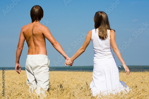 Image of couple walking along the field