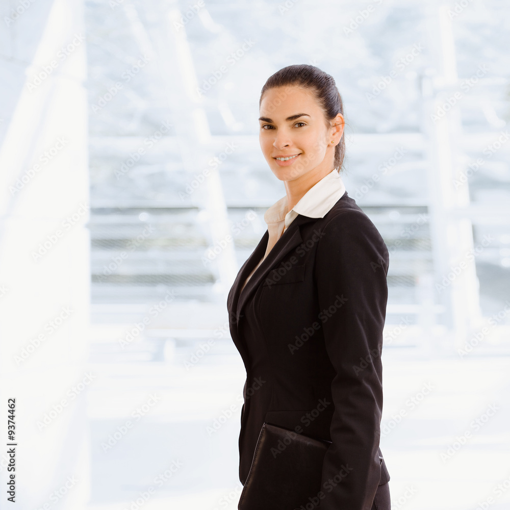 Happy young businesswoman holding notebook, smiling. Happy young businesswoman holding notebook, smiling.