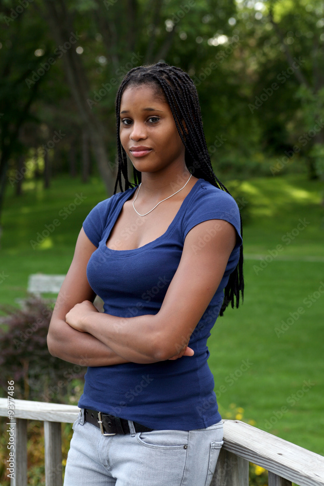 pretty black teenage girl standing in the park pretty black teenage girl standing in the park