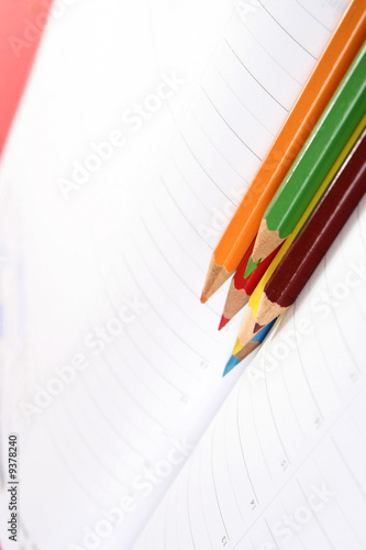 Close-up of color pencils and agenda