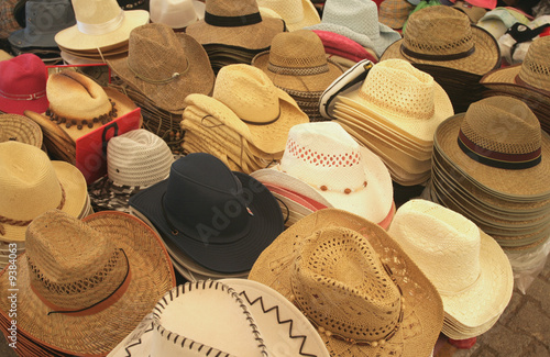 Selling hats in a market place. Clothing accessories.