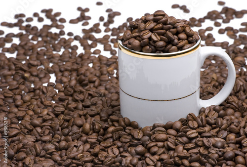 White coffee cup with many coffee beans
