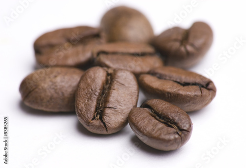 Close up of group of coffee beans isolated on white background