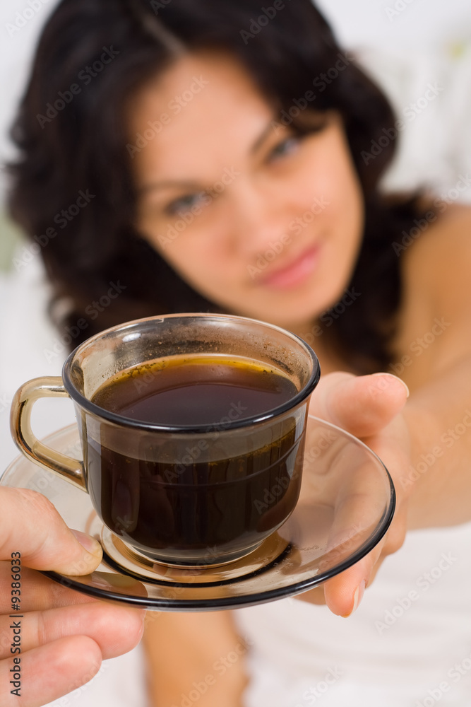 A man giving a young woman a cup of coffee - part of a series. A man giving a young woman a cup of coffee - part of a series.