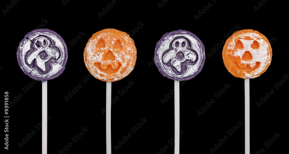 Four halloween suckers isolated on a black background Four halloween suckers isolated on a black background
