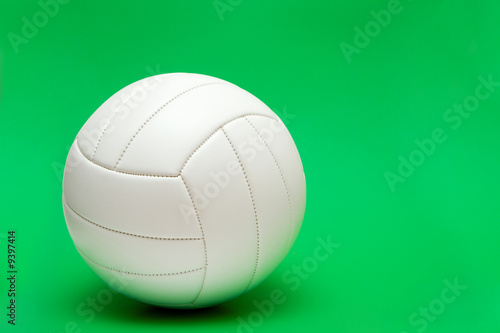 white volleyball isolated on the green background