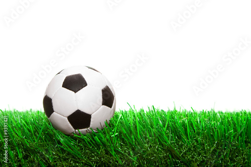 small soccer ball on the grass isolated on white background