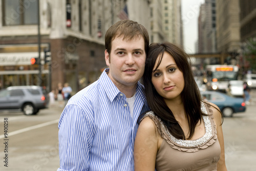 Couple posing in street looking serious.