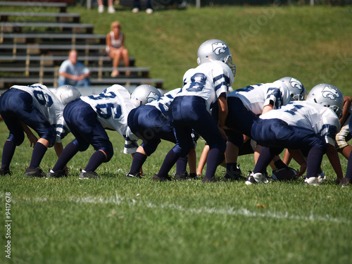 a young american football team ready at the line of scrimmage