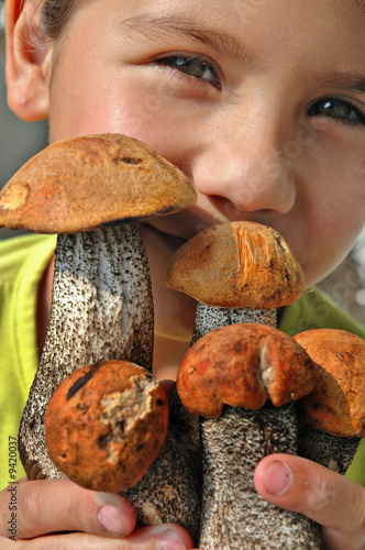 The girl holds in hands some fresh aspen mushrooms