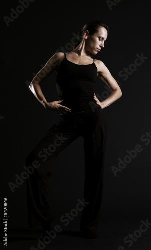 young dancer posing over dark background