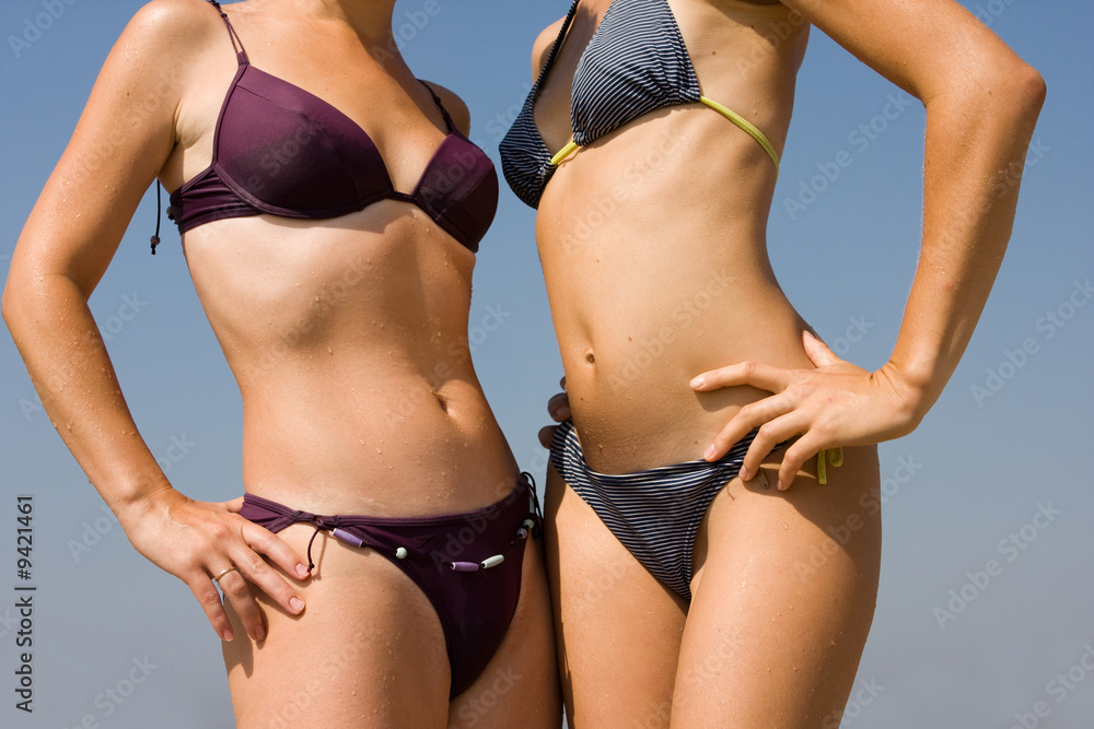Beautiful girls in swimsuits relaxing on the beach Beautiful girls in swimsuits relaxing on the beach