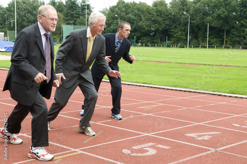 Group of businessmen are ready for the start of the run.