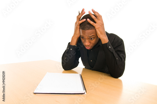 man sits at table with anxious look on face