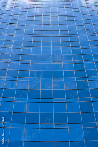 Mirror facade of a building with reflection of the sky