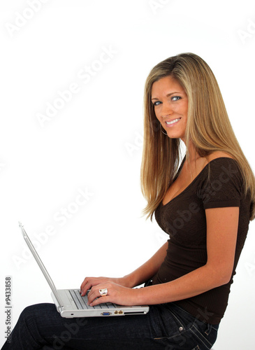 Happy young woman working o...