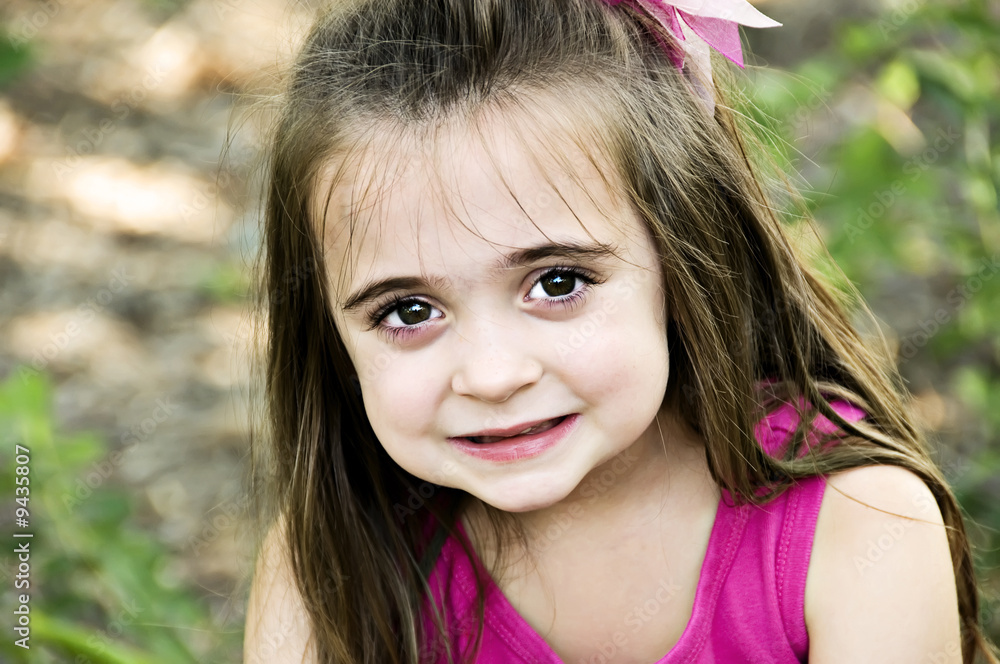 Beautiful brunette child smiling with big brown eyes. Beautiful brunette child smiling with big brown eyes.