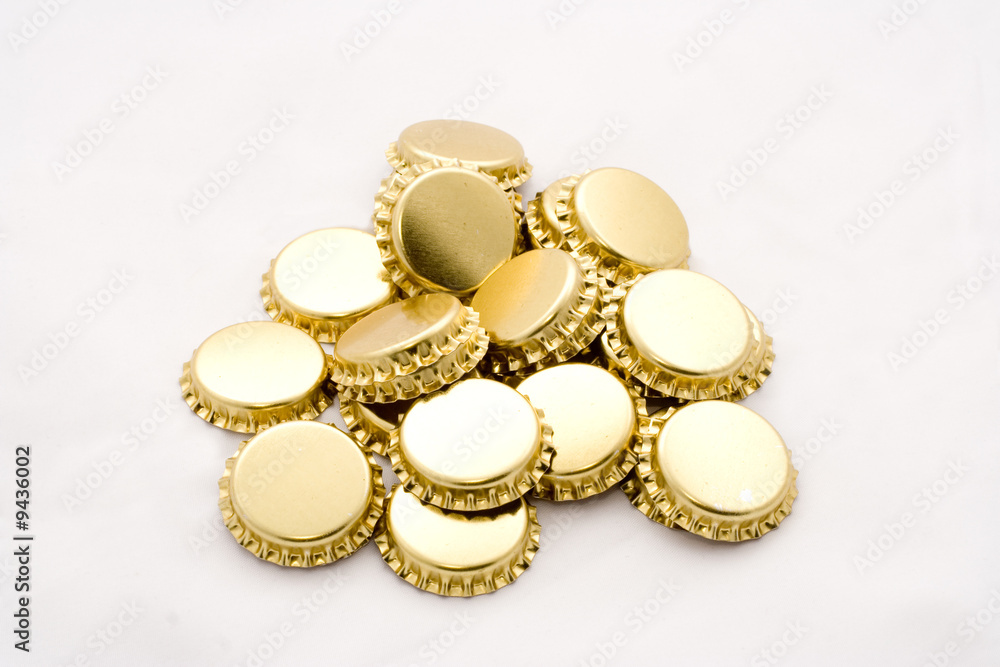 Pile of golden beer bottle caps Pile of golden beer bottle caps