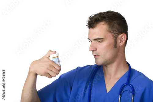 pharmacist looking at pill bottle
