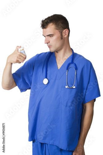 doctor looking at pill bottle
