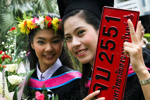 Gorgeous Asian university graduates celebrating their success. photo