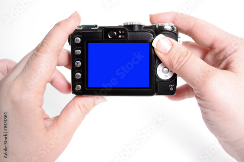 woman's hands hold camera with blank screen,