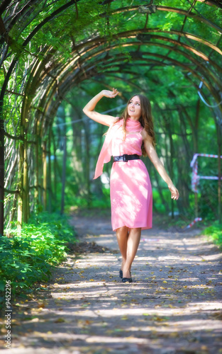 Young happy woman walking in a park.