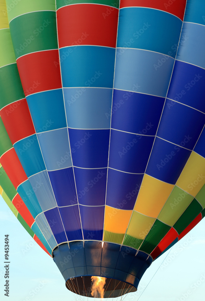Obraz premium Propane burners being fired in a colourful hot air balloon.