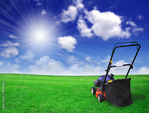 Lawn mower on green field