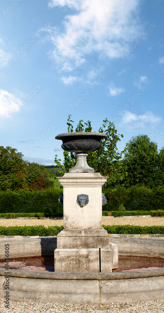 Vintage stone fountain in a country garden