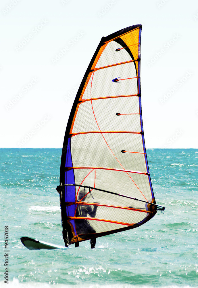 Fototapeta premium Silhouette of a windsurfer on the sea
