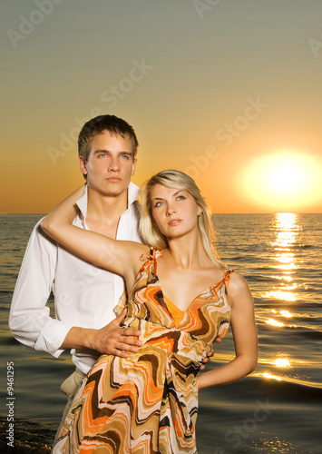 Young couple in love near the ocean at sunset © Nejron Photo