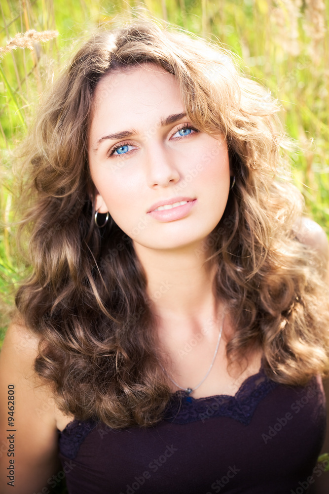 Young woman on a summer field.