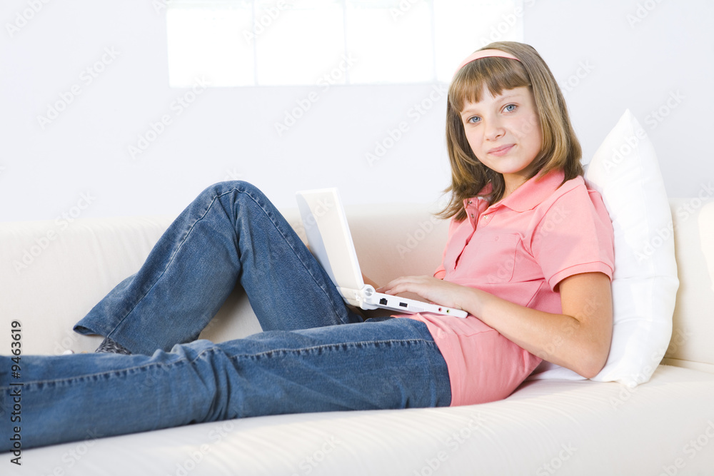 Girl with laptop on couch Girl with laptop on couch