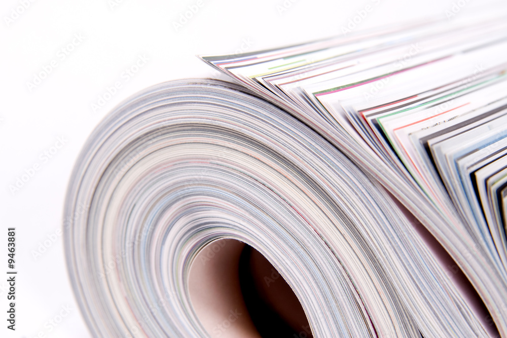 Three color magazines rolled on white background Three color magazines rolled on white background