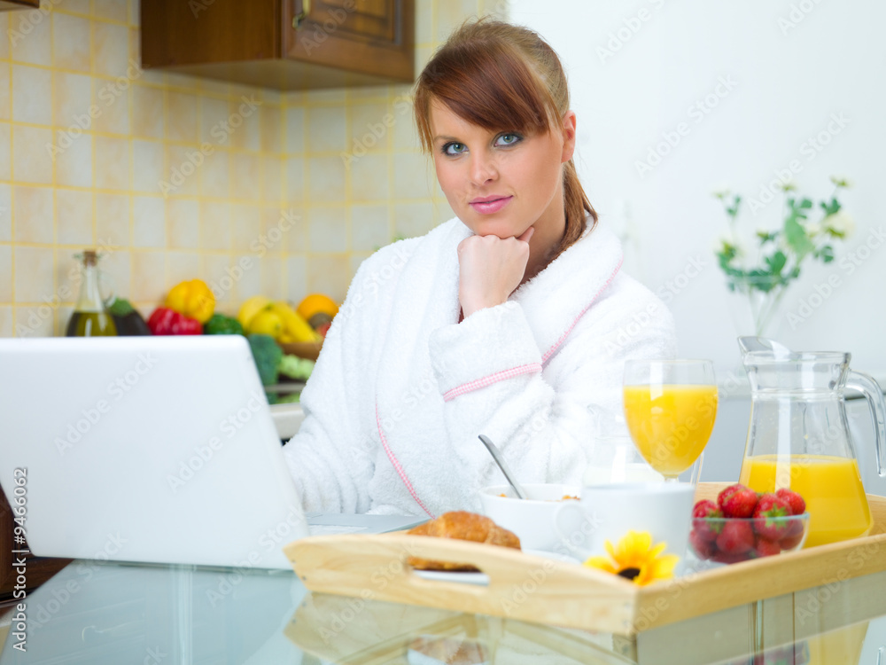 Beautiful woman in kitchen eating tasty breakfast Beautiful woman in kitchen eating tasty breakfast