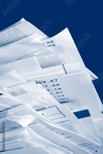 a stack of due  monthly bill payments in blue tones