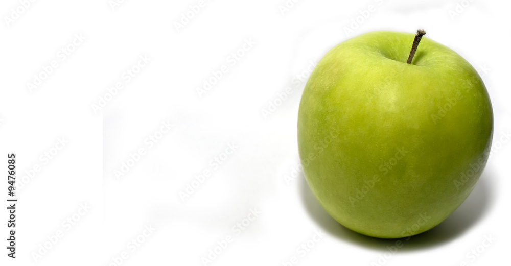 A ripe granny SMith apple over a plain white background