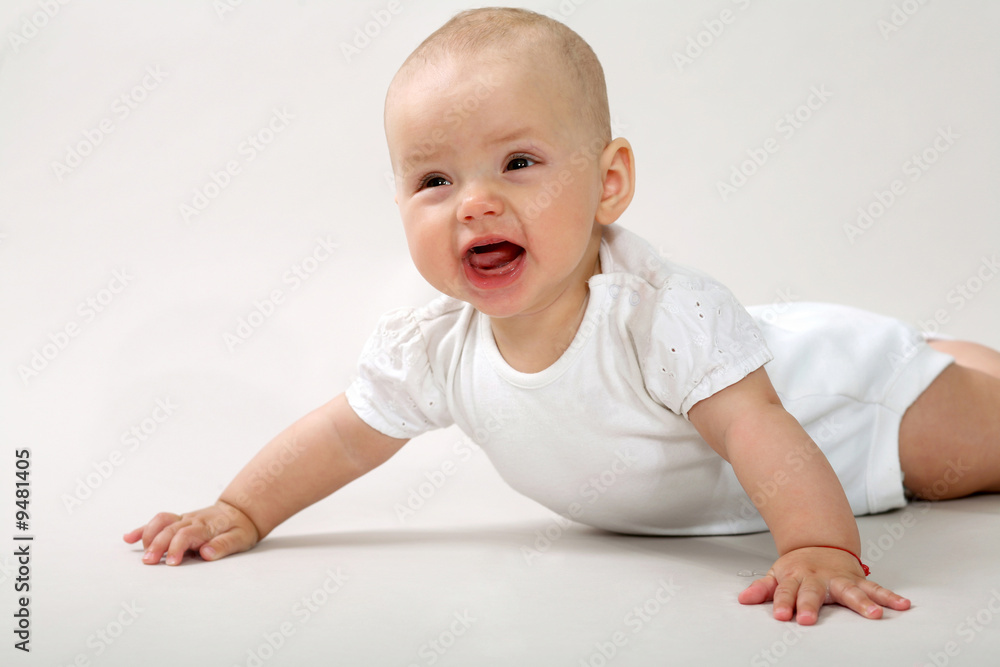 An image of a little baby crawning in studio An image of a little baby crawning in studio