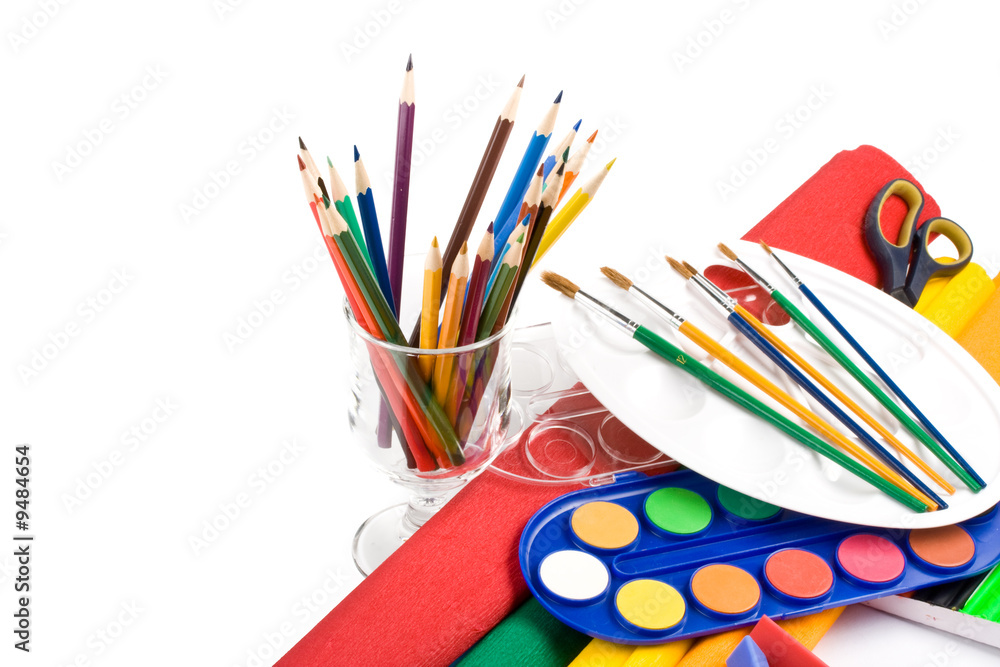 Fototapeta premium Water colour paints, pencils and brushes on a white background