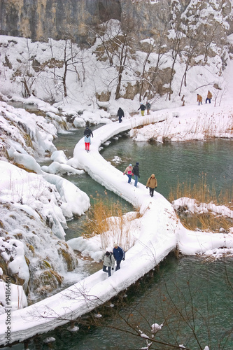 Plitvice - winter landscape with lake, path and some tourists