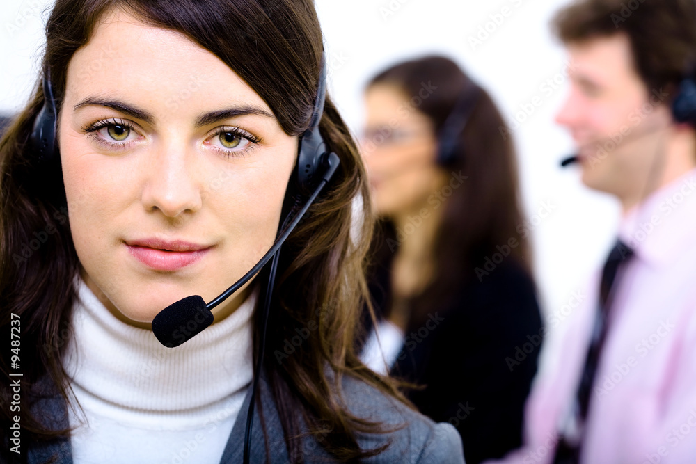 Customer service team working in headsets, smiling. Customer service team working in headsets, smiling.