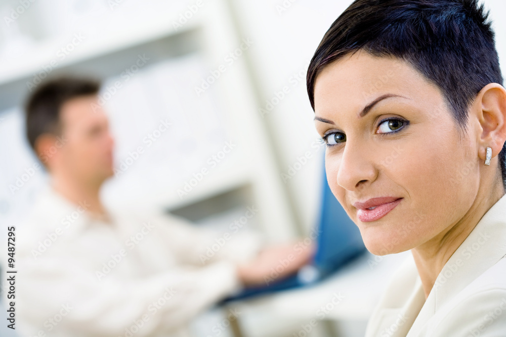 Portrait of businesswoman at office, smiling. Portrait of businesswoman at office, smiling.