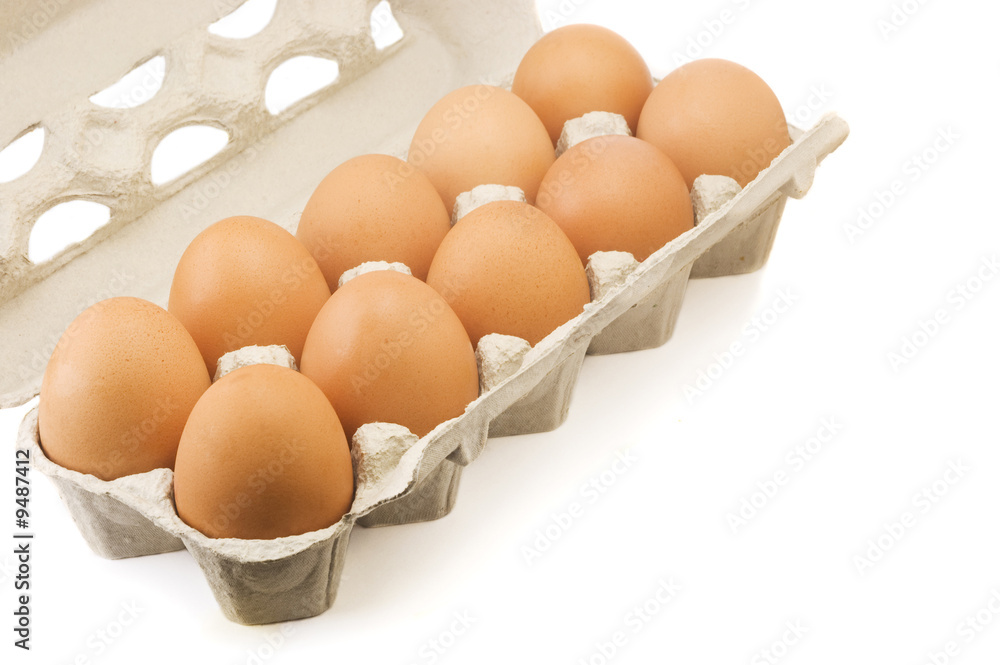 Ten brown eggs in a cardboard carton