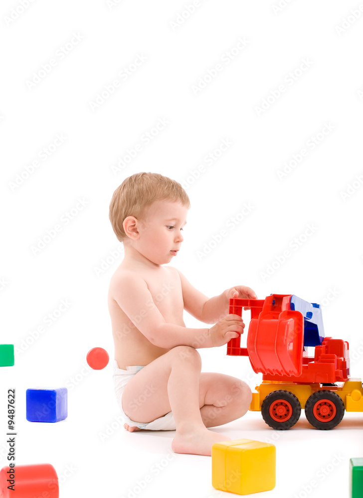 Little boy play with toys over white background Little boy play with toys over white background