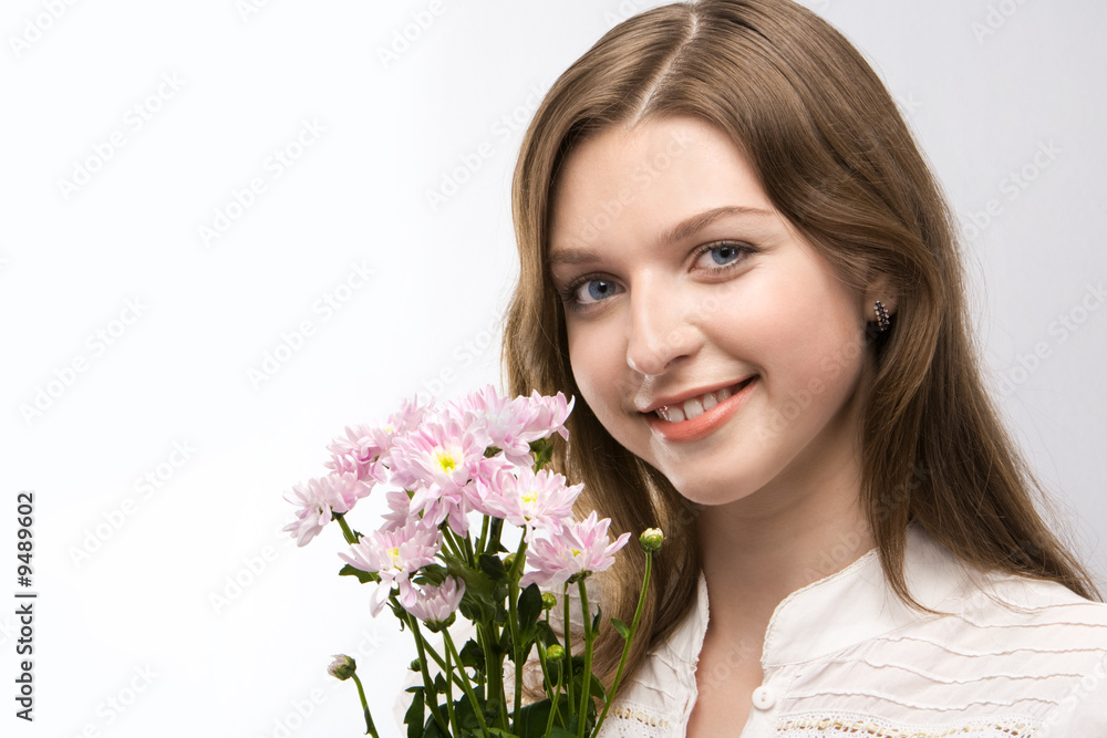 Portrait of smiling girl with pink bouquet looking at camera Portrait of smiling girl with pink bouquet looking at camera