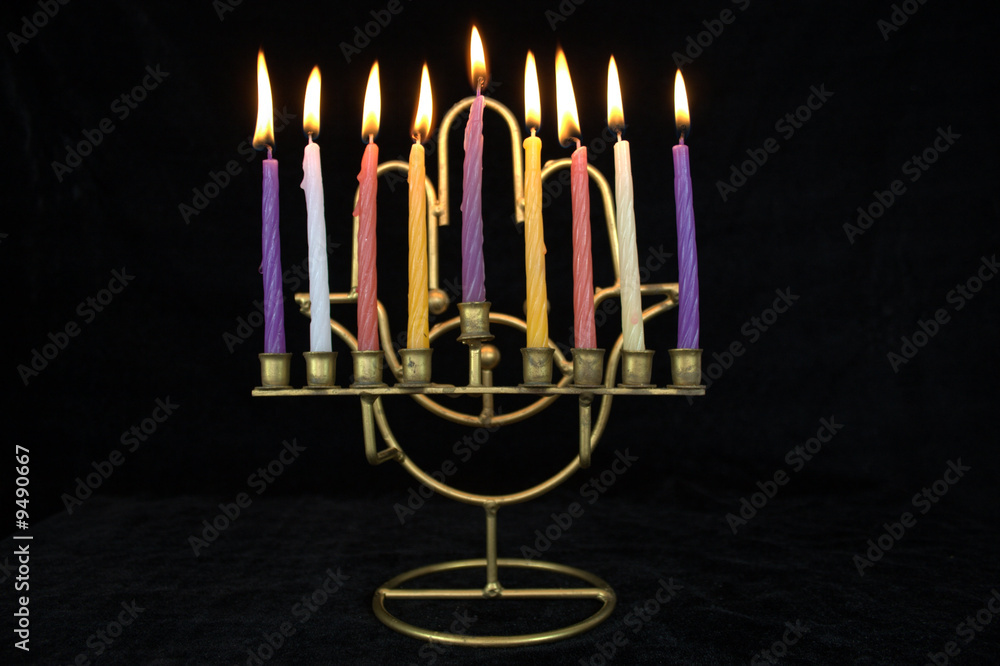 Fototapeta premium hanukiah with all the candles burning on black background