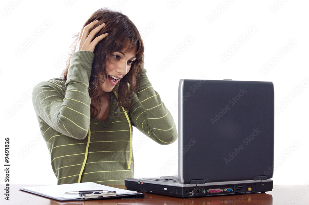 Beautiful surprised girl while looking at the laptop Beautiful surprised girl while looking at the laptop